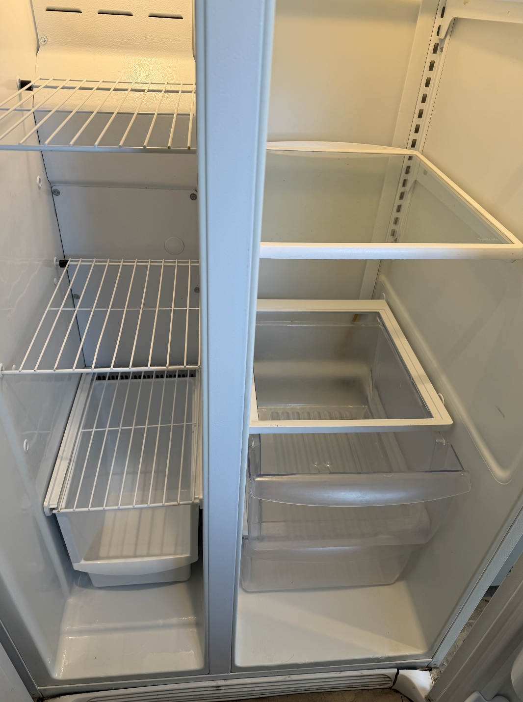 Refrigerator interior after cleaning with spotless shelves and drawers.